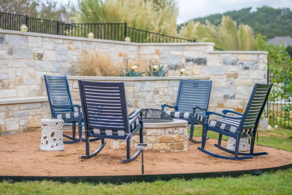 A fire pit with custom landscape and hardscape design surrounding it.