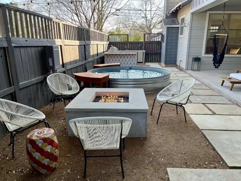 Hardscape 10 Outdoor Living Space Ideas Worth Stealing for Your Austin Backyard 8 A cute backyard with a stone structure for lighting a fire on a cold Austin night